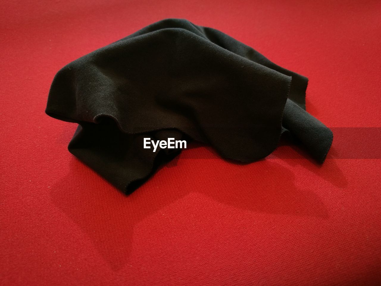 CLOSE-UP OF RED OBJECT OVER WHITE BACKGROUND