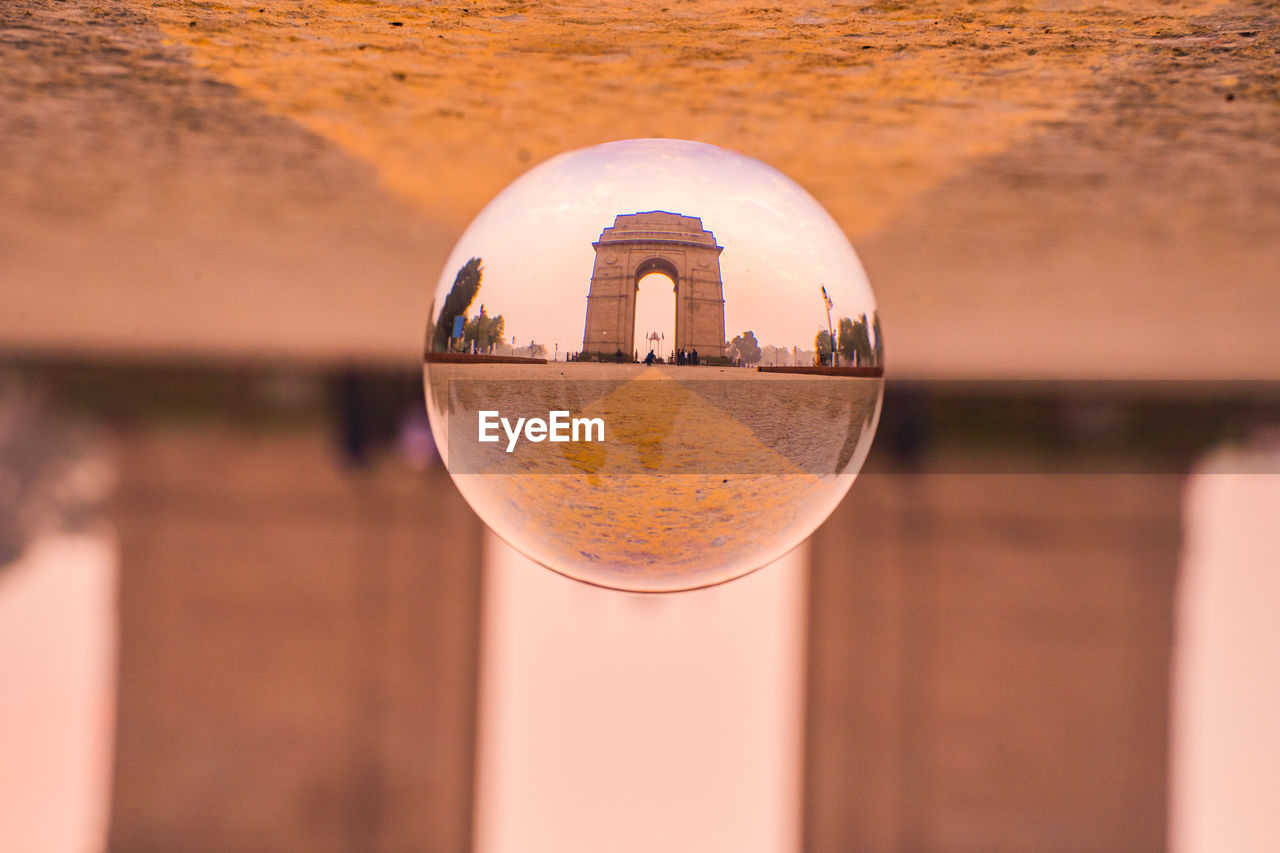 CLOSE-UP OF CRYSTAL BALL WITH REFLECTION OF WATER