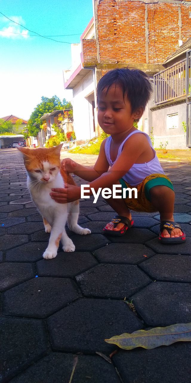 CUTE GIRL PLAYING WITH DOG AT PARK