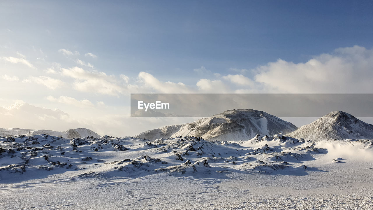 Scenic view of snowcapped mountains against sky. iceland