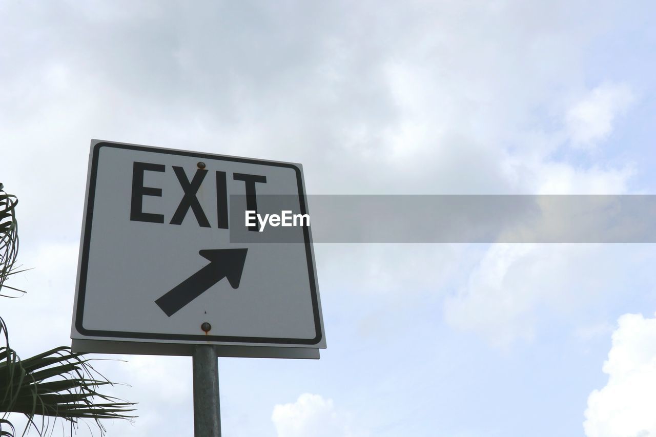 LOW ANGLE VIEW OF SIGN BOARD AGAINST CLOUDY SKY