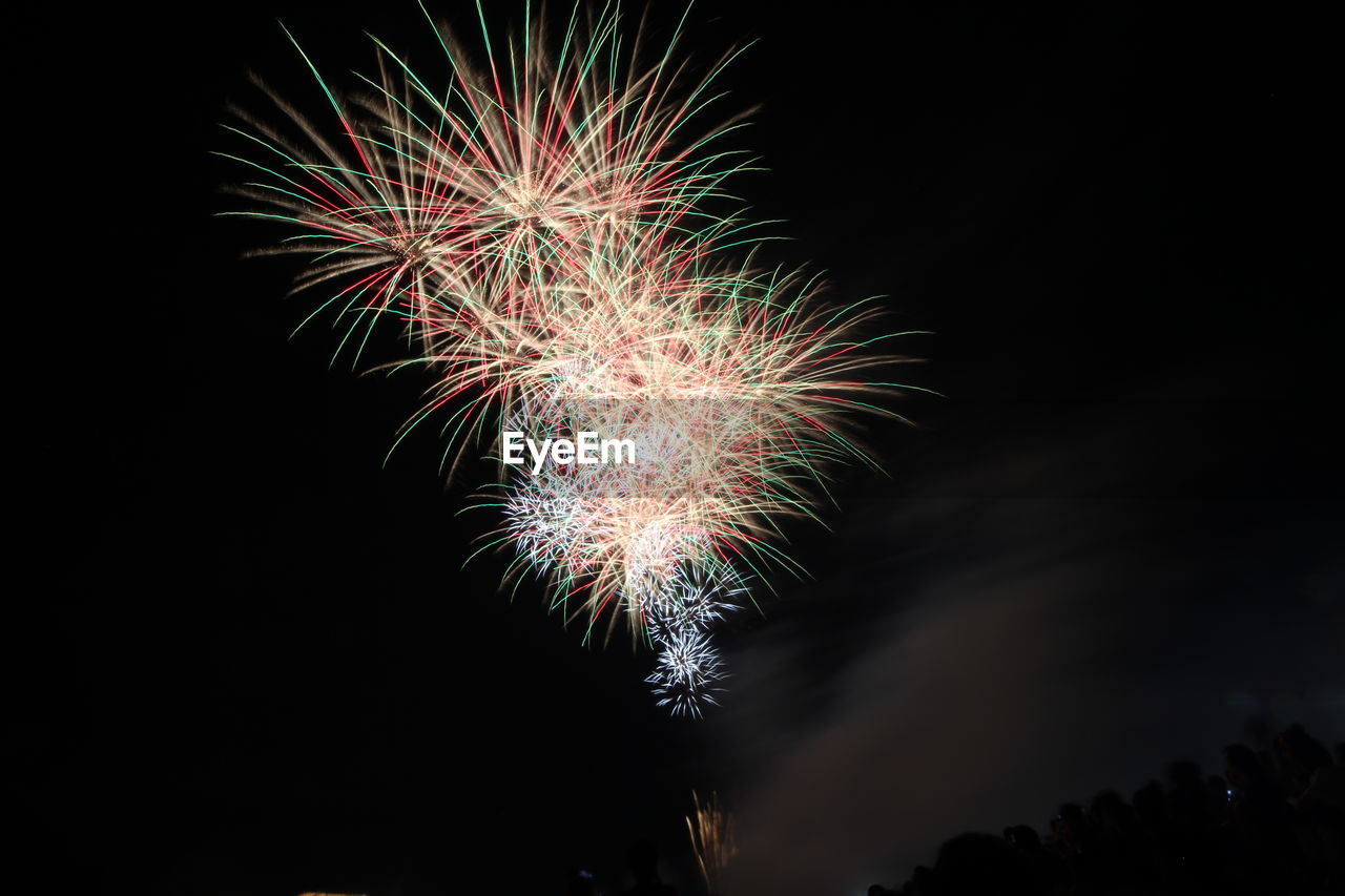 Low angle view of firework display at night