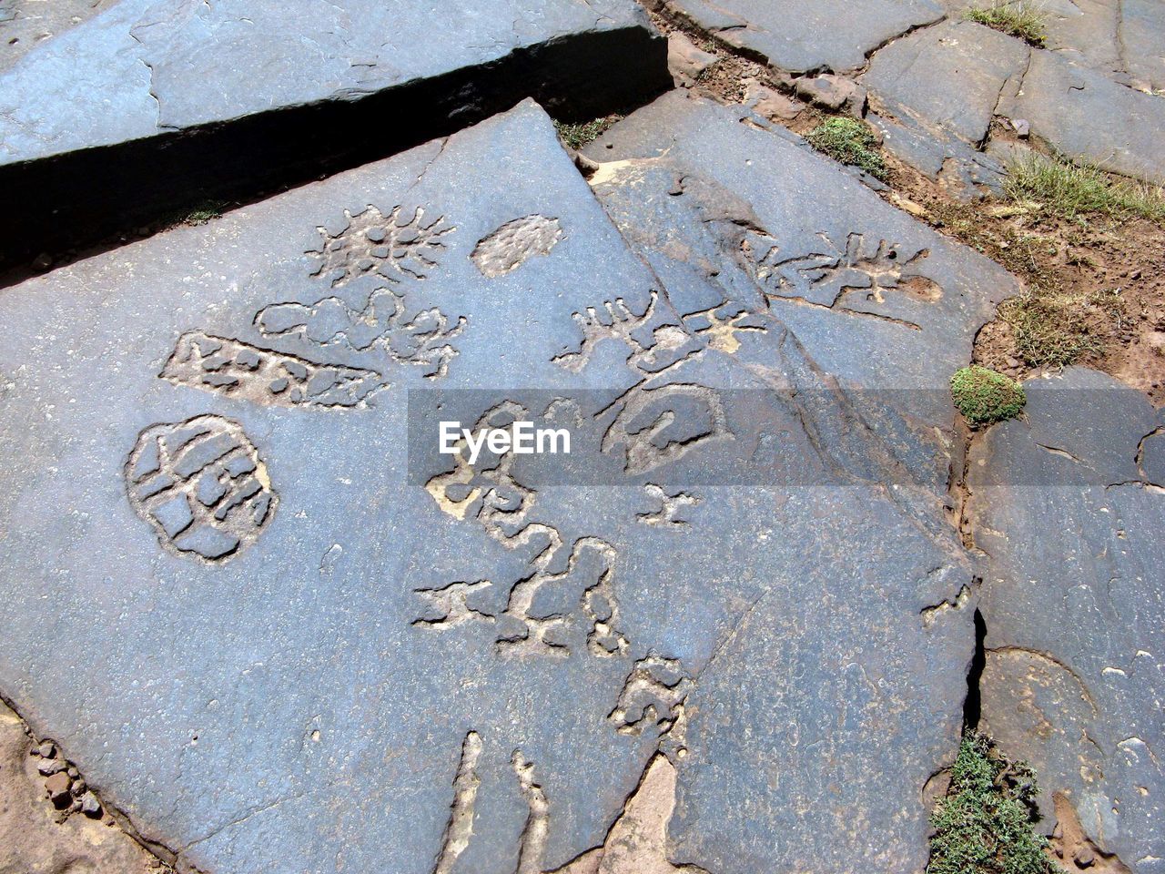 HIGH ANGLE VIEW OF TEXT ON WET ROAD