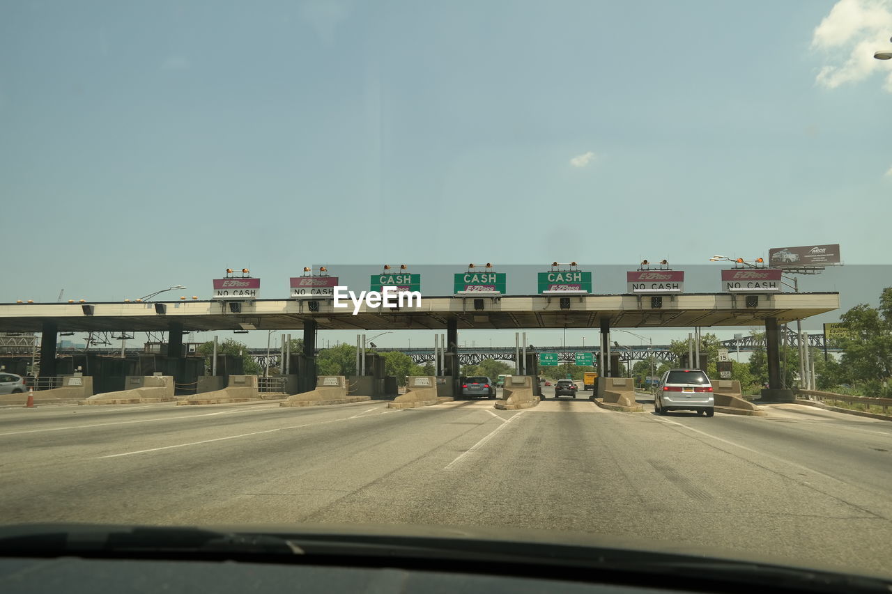 Cars at toll booth seen through windshield