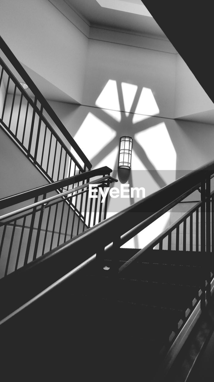 LOW ANGLE VIEW OF STAIRS IN SPIRAL STAIRCASE