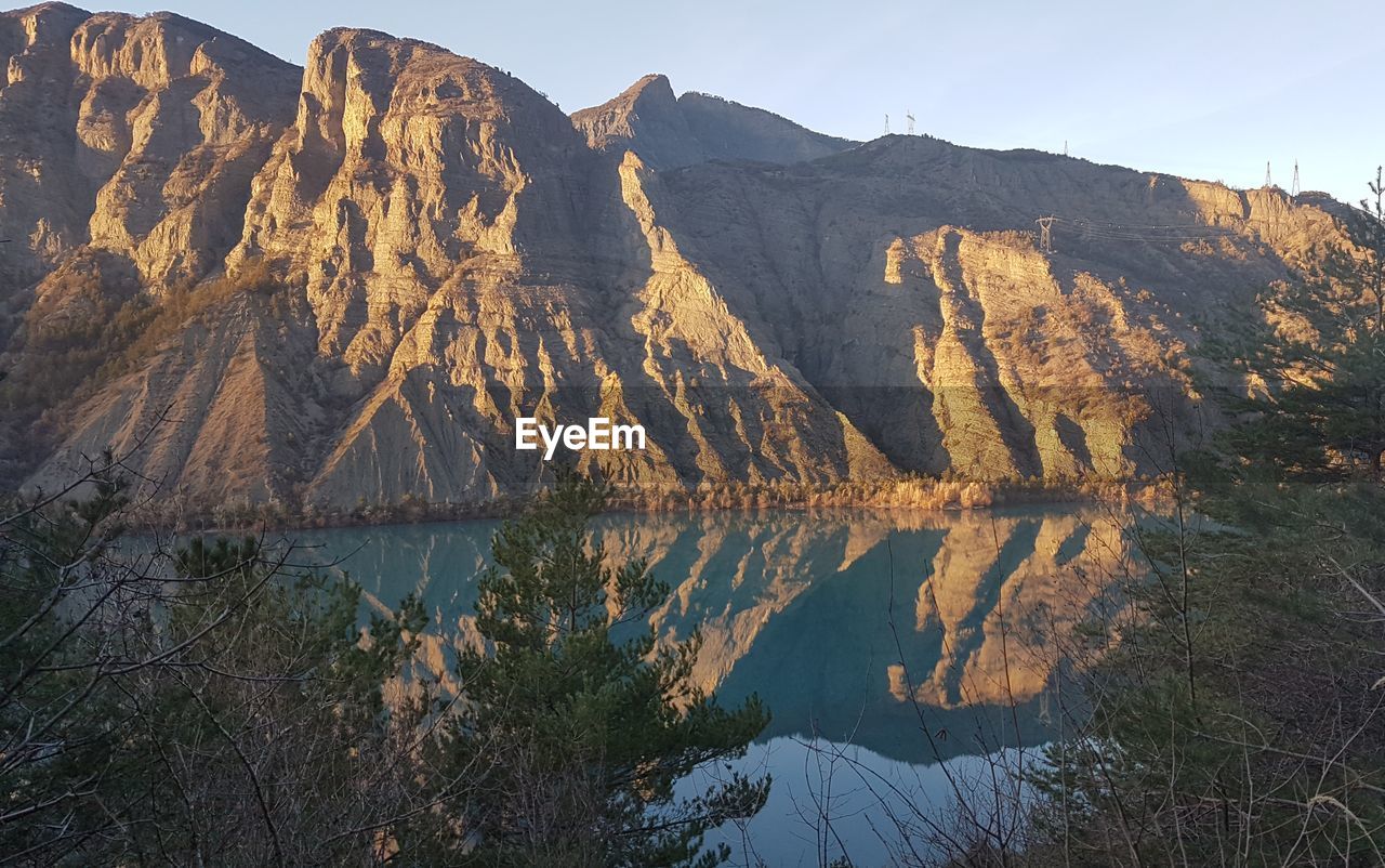 Scenic view of lake and mountains against sky