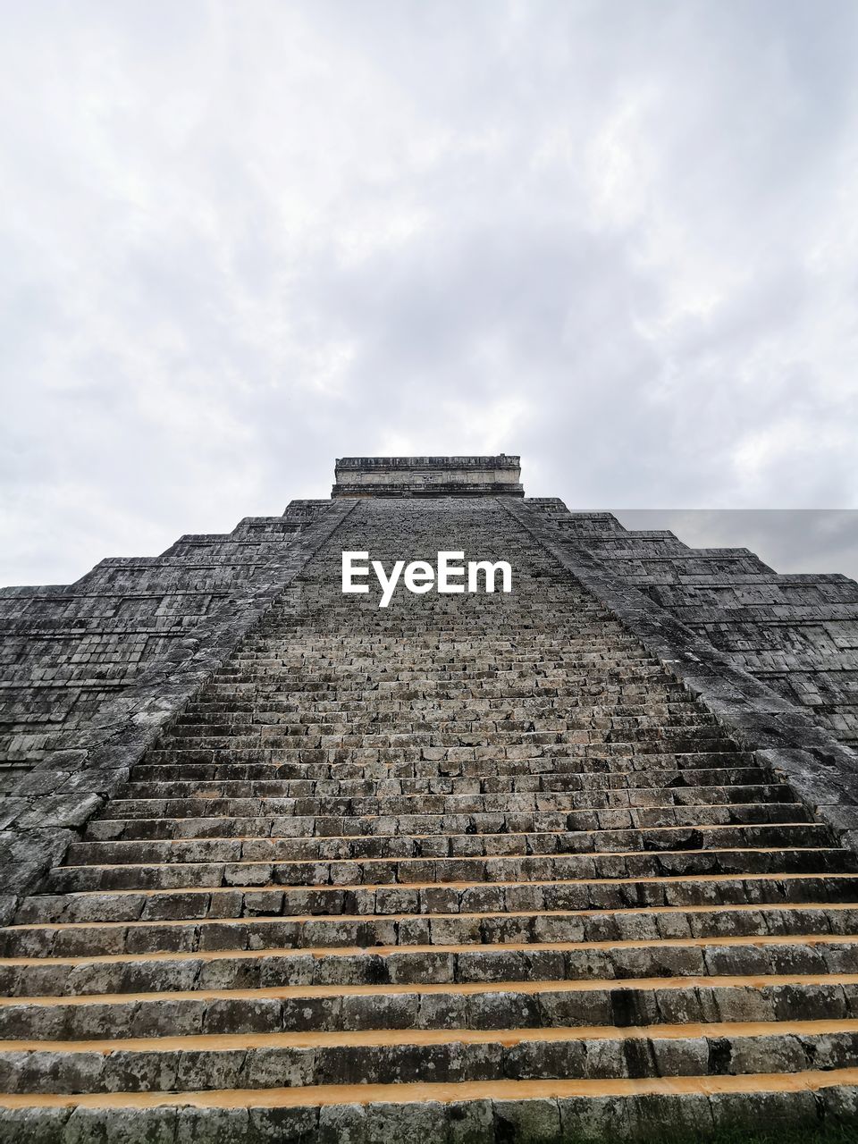 Low angle view of old building against cloudy sky