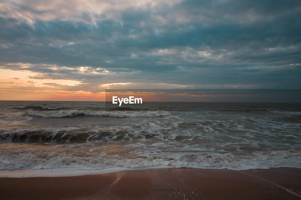 SCENIC VIEW OF BEACH DURING SUNSET