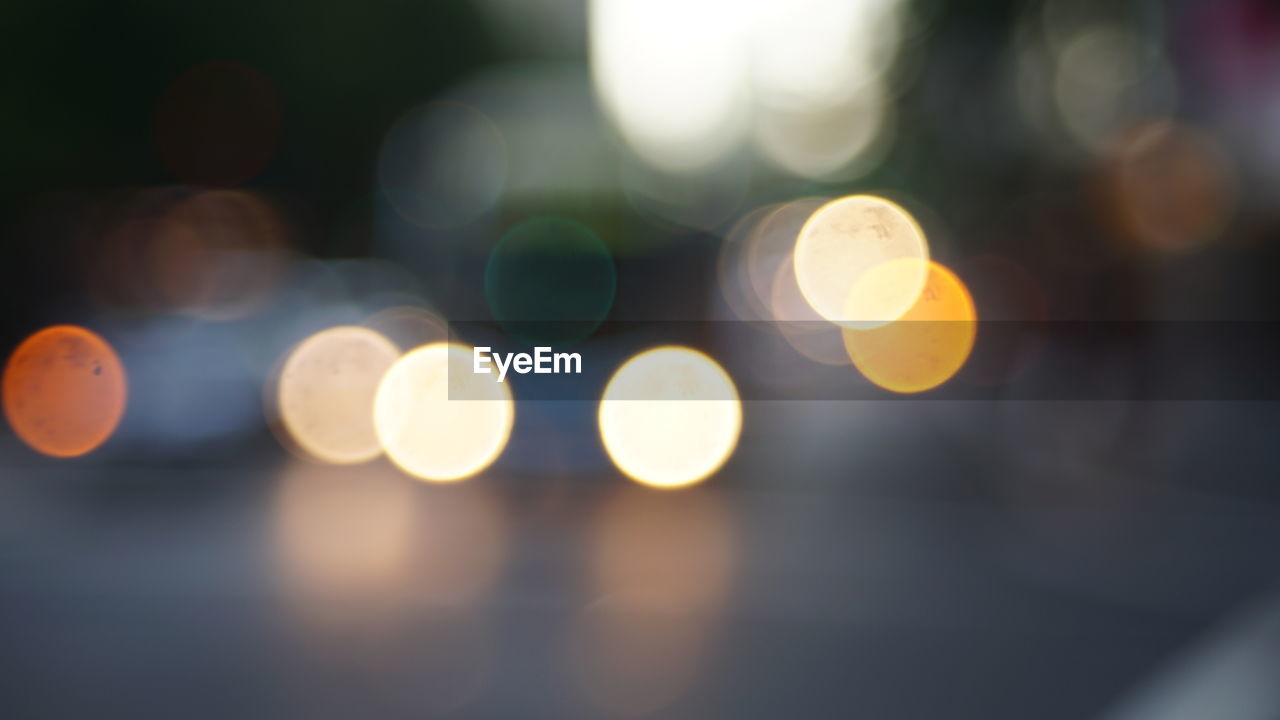 Defocused image of illuminated street lights at night