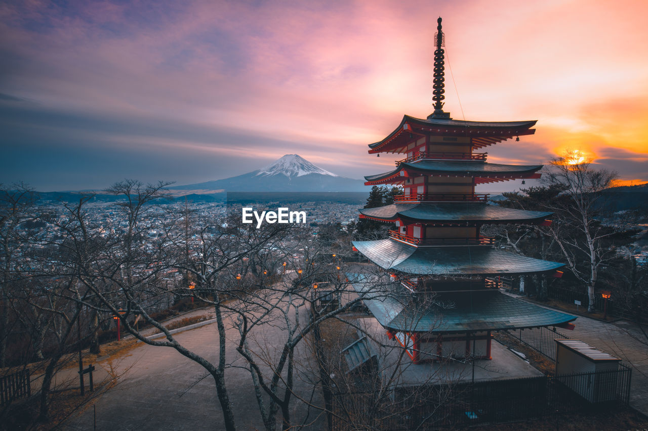 Pagoda against cloudy orange sky during sunset