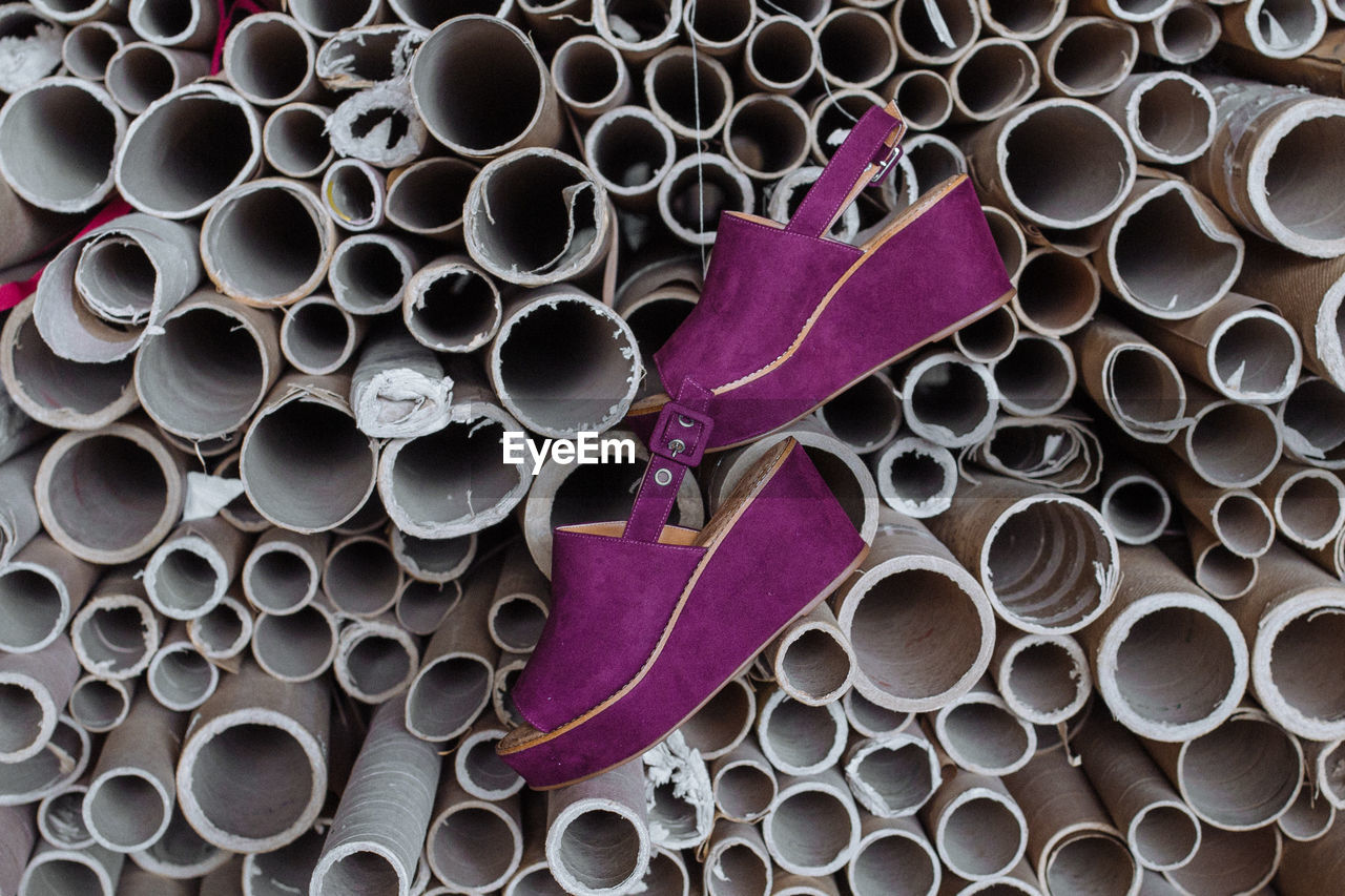Purple shoes hanging from pipes