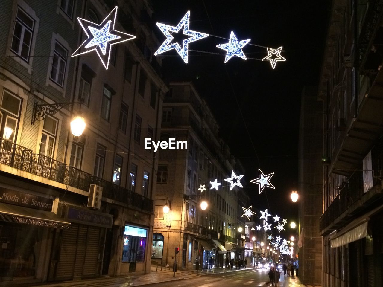 VIEW OF ILLUMINATED STREET LIGHTS AT NIGHT