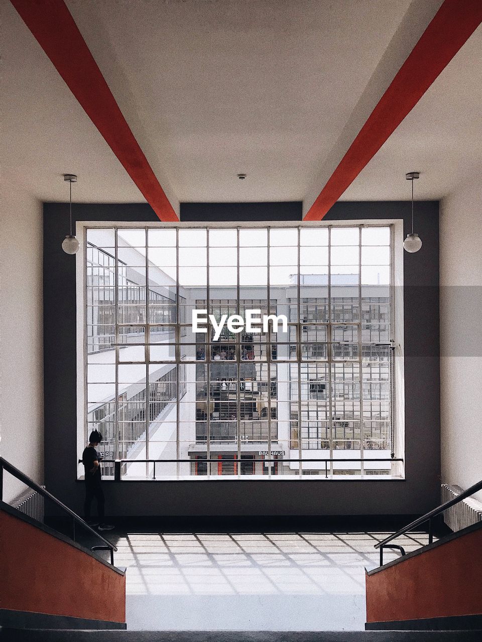 LOW ANGLE VIEW OF BUILDING SEEN THROUGH GLASS WINDOW