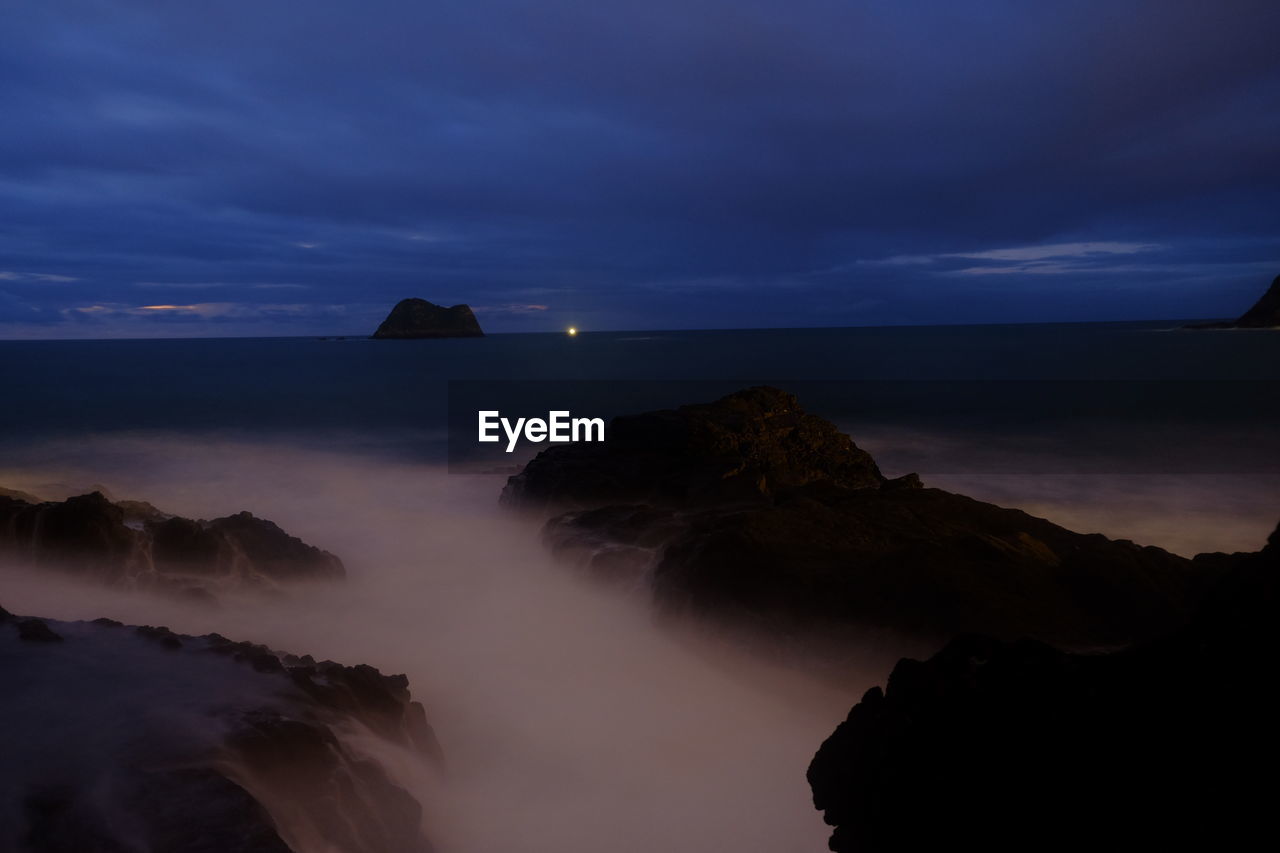 Scenic view of sea against sky at sunset