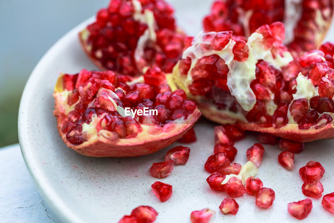 food and drink, food, pomegranate, healthy eating, fruit, plant, wellbeing, pomegranate seed, freshness, red, seed, produce, no people, berries, berry, studio shot, antioxidant, close-up, juicy, cross section, slice, cranberry, vitamin, sweet food, ripe, indoors