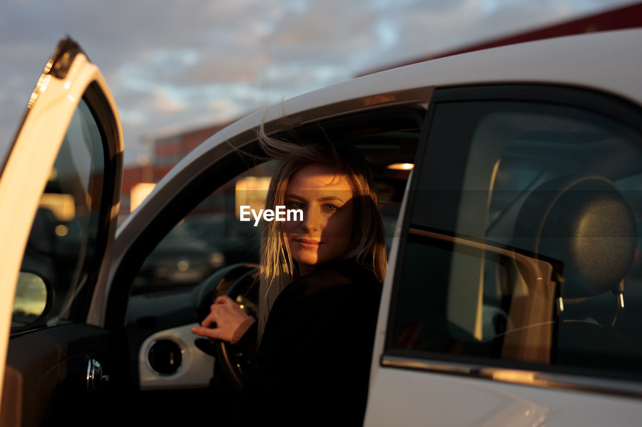 Portrait of young woman in car