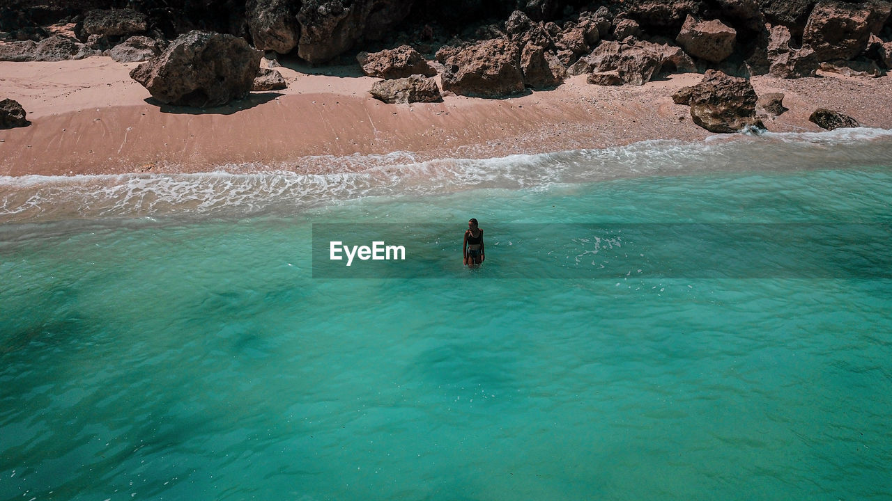 Aerial view of woman standing on beach