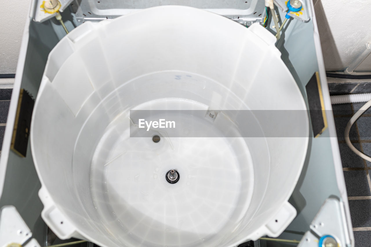 HIGH ANGLE VIEW OF FAUCET IN CONTAINER AT NIGHT