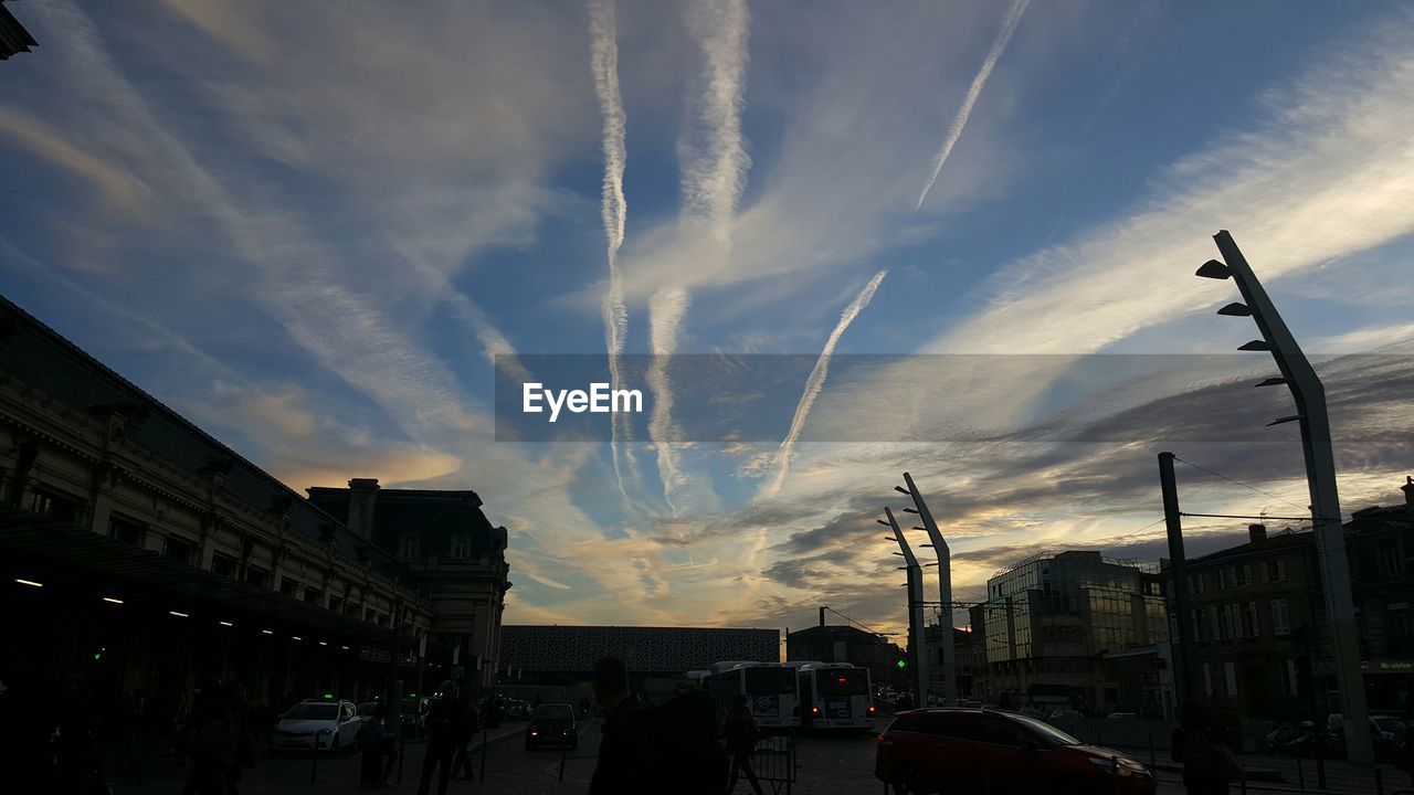 VIEW OF CITY STREET AGAINST CLOUDY SKY