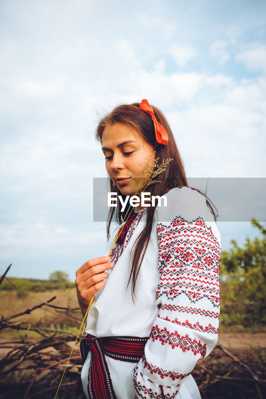 Photo of a smiling young woman in ethnic ukrainian shirt