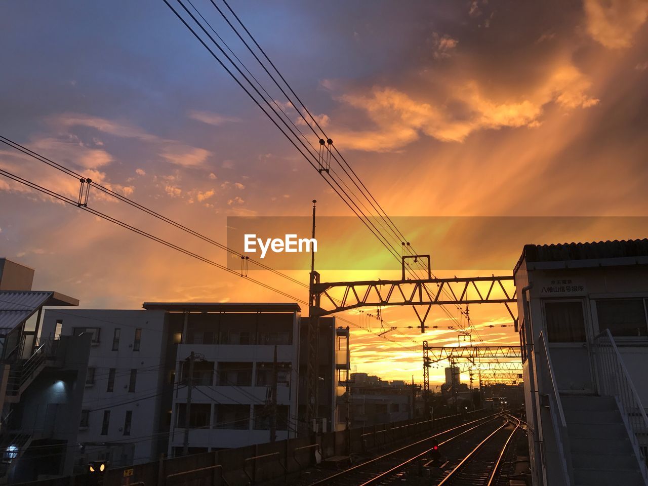 SILHOUETTE OF TRAIN AGAINST SKY DURING SUNSET