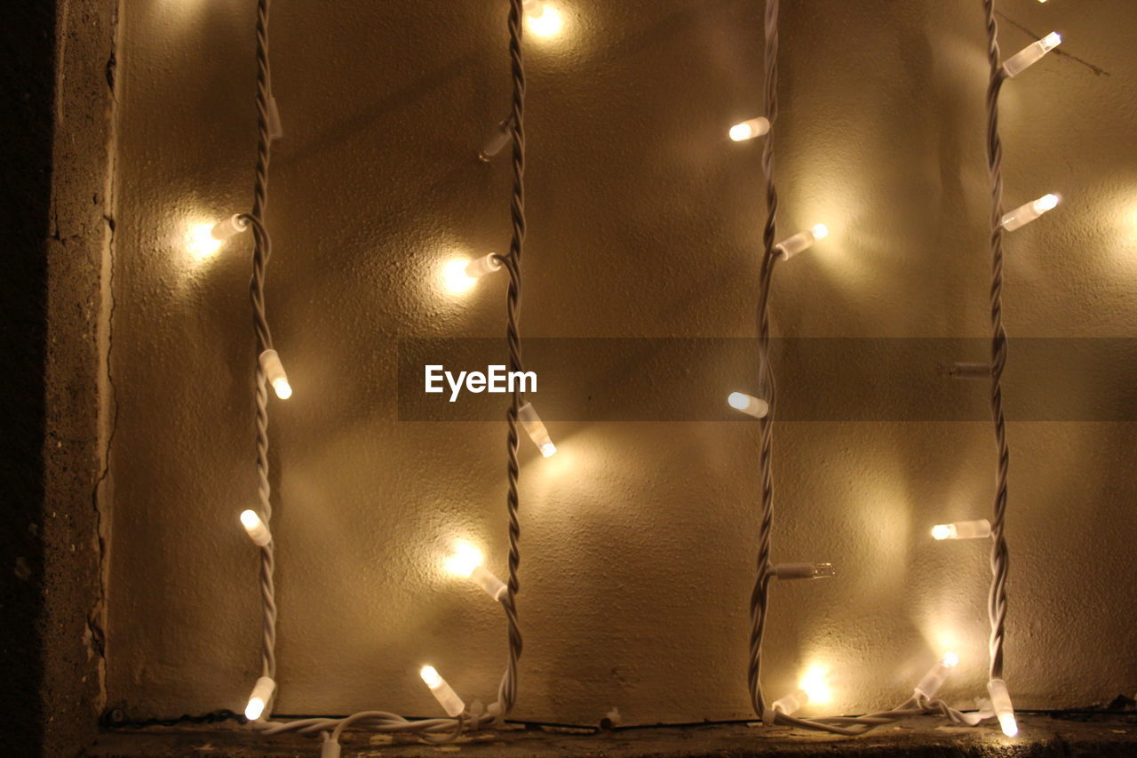 CLOSE-UP OF ILLUMINATED ELECTRIC LAMP