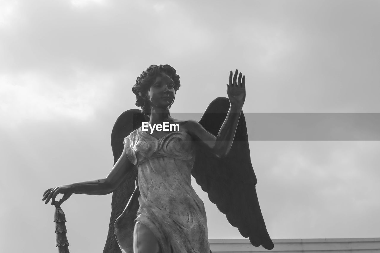 Low angle view of statue against sky