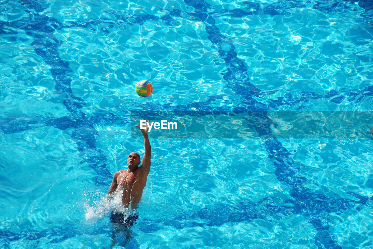 Man playing water sport in pool