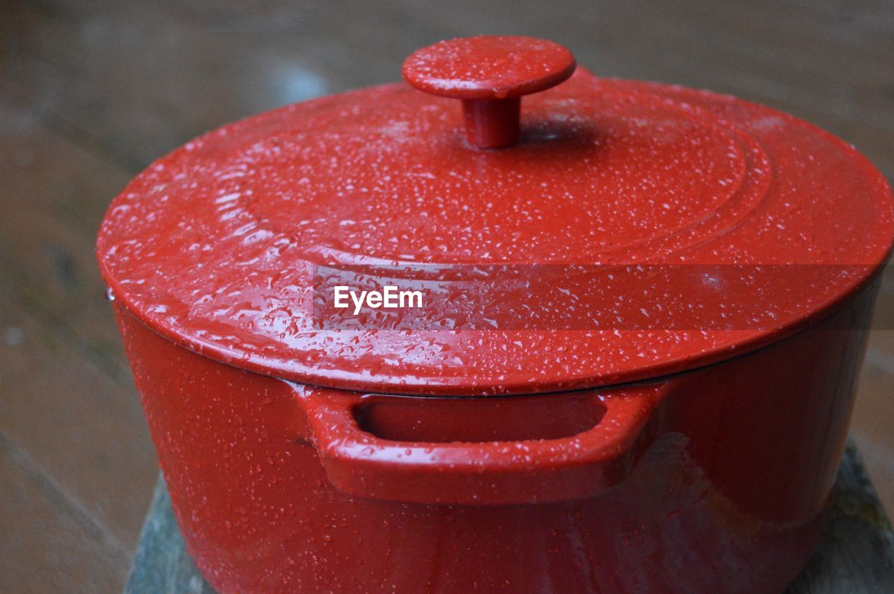 High angle view of raindrops on red metal