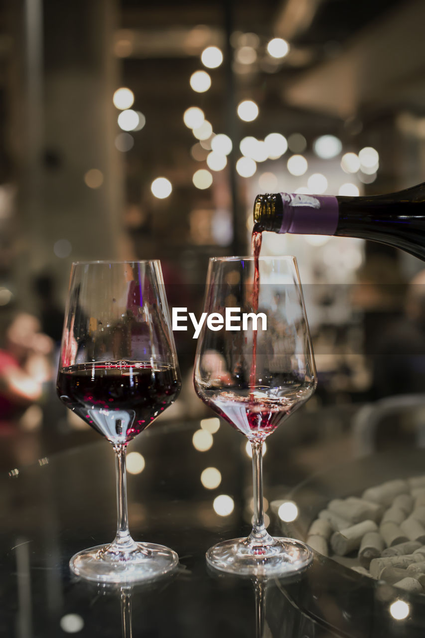 CLOSE-UP OF GLASS OF WINE ON TABLE