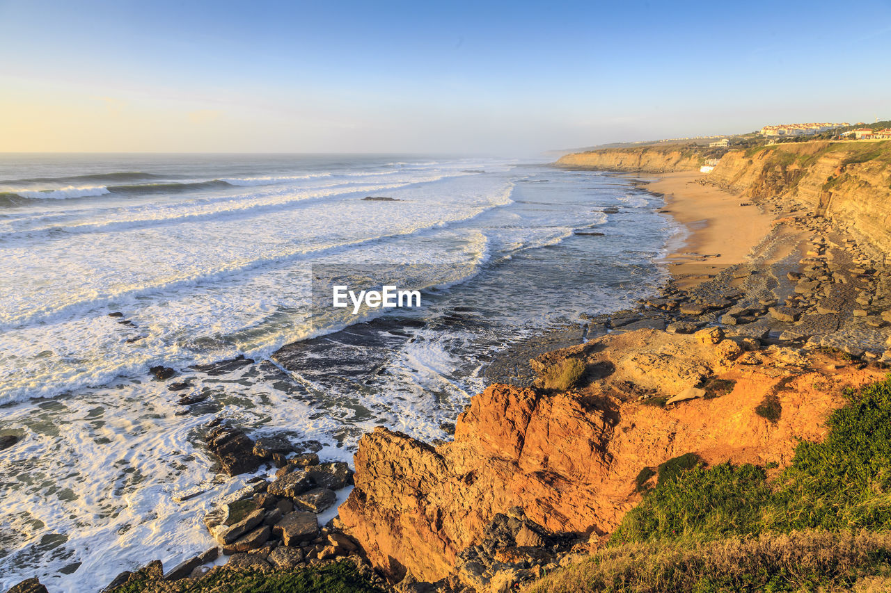 Scenic view of beach against sky during sunset