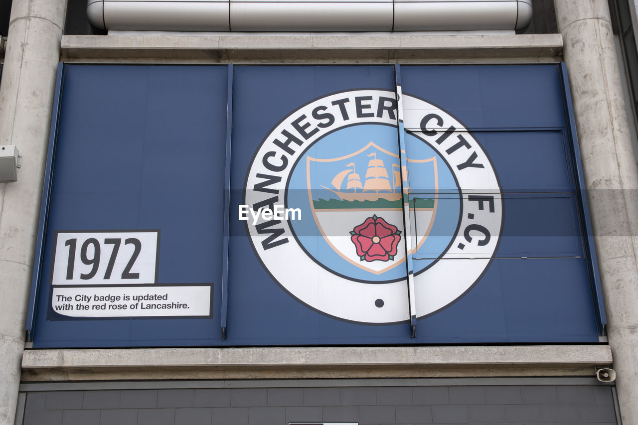 CLOSE-UP OF SIGN ON BLUE WALL