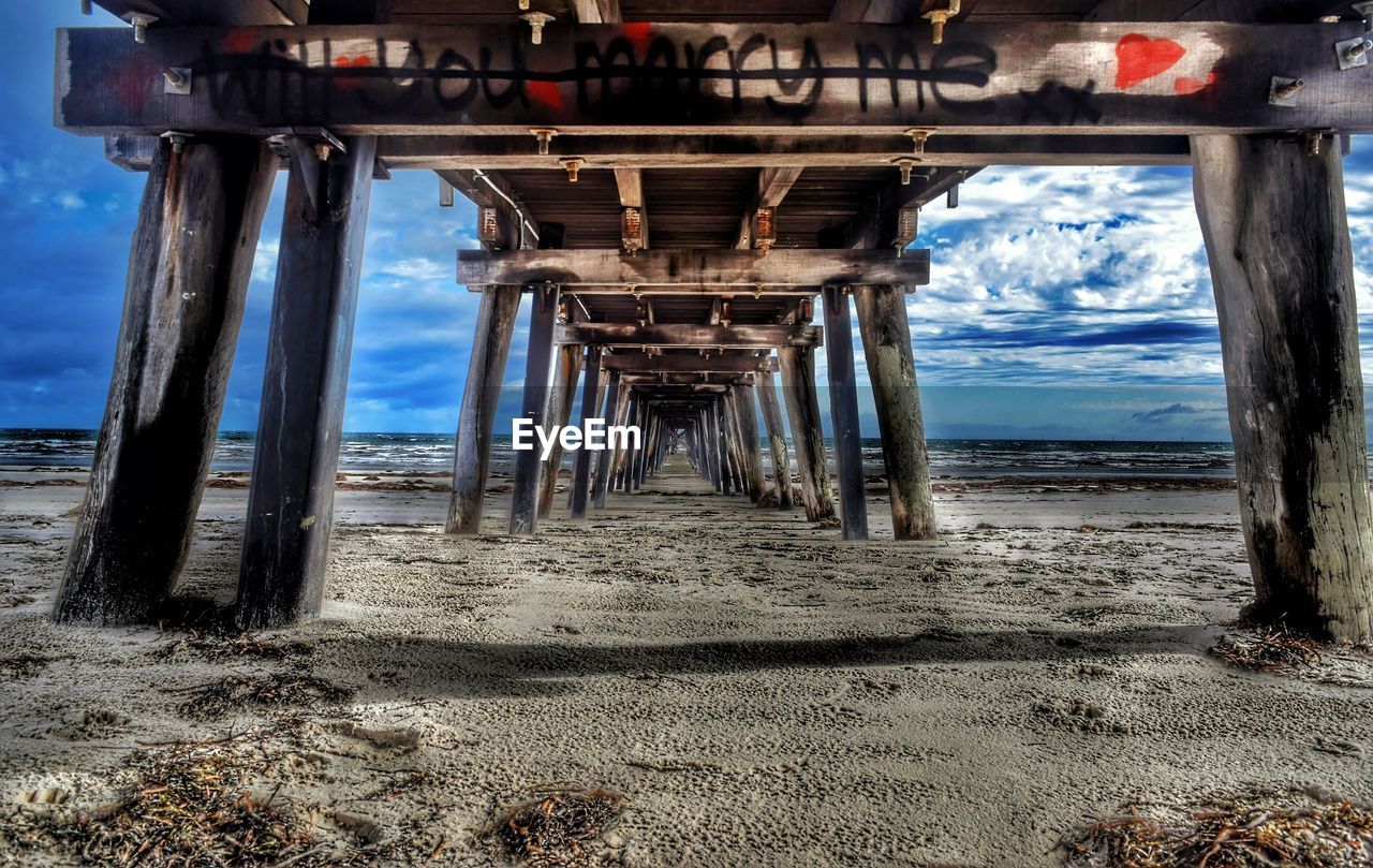 Graffiti under pier at beach