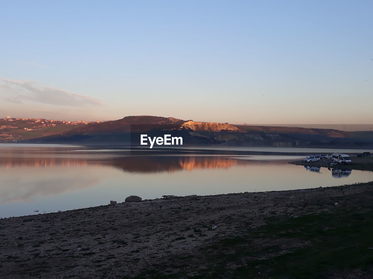 SCENIC VIEW OF LAKE AGAINST SKY DURING SUNSET