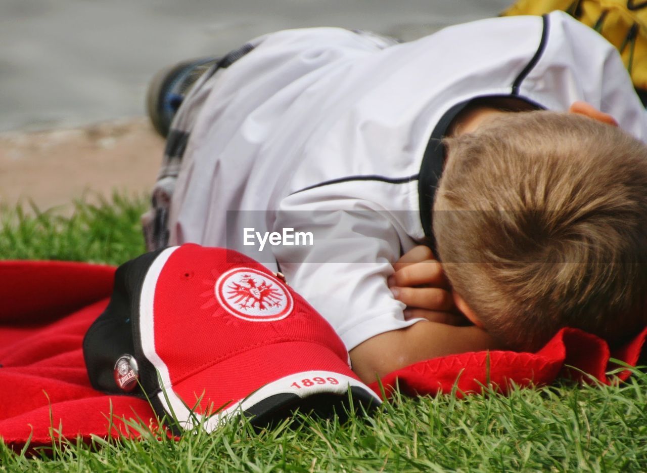 BOY LYING DOWN IN GRASS