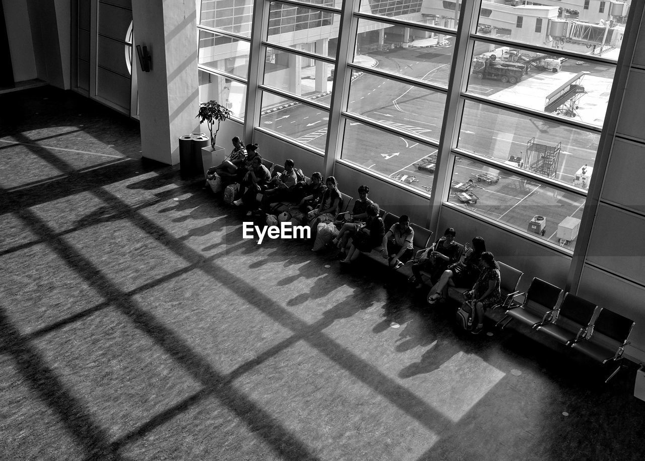 High angle view of people sitting on tiled floor