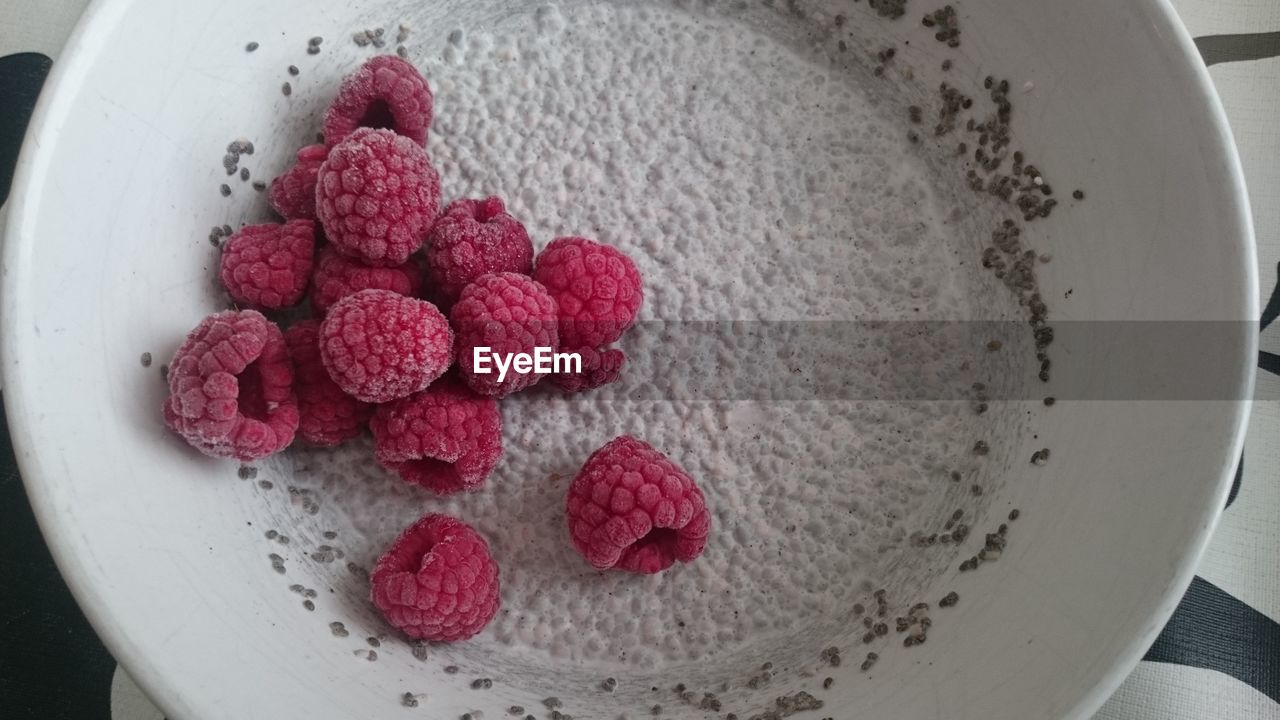 Close-up of raspberry with coconut milk and chia seeds
