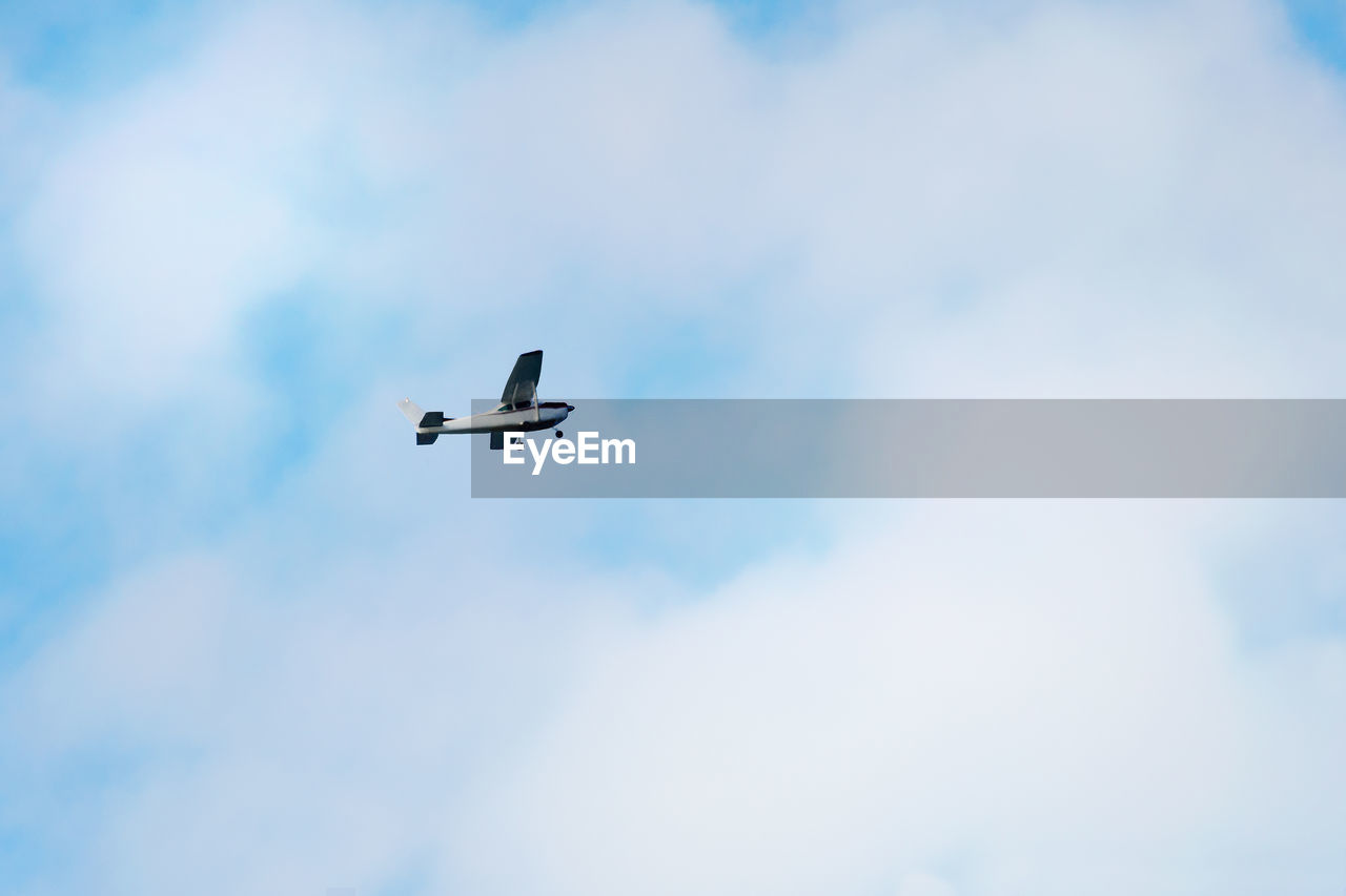 LOW ANGLE VIEW OF AIRPLANE AGAINST SKY