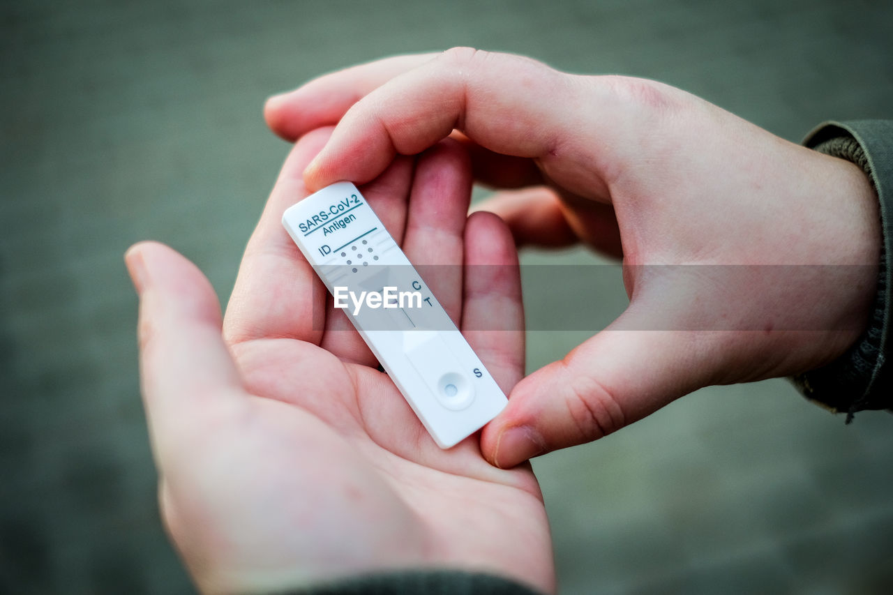 Close-up of woman holding covid-19 testing kit