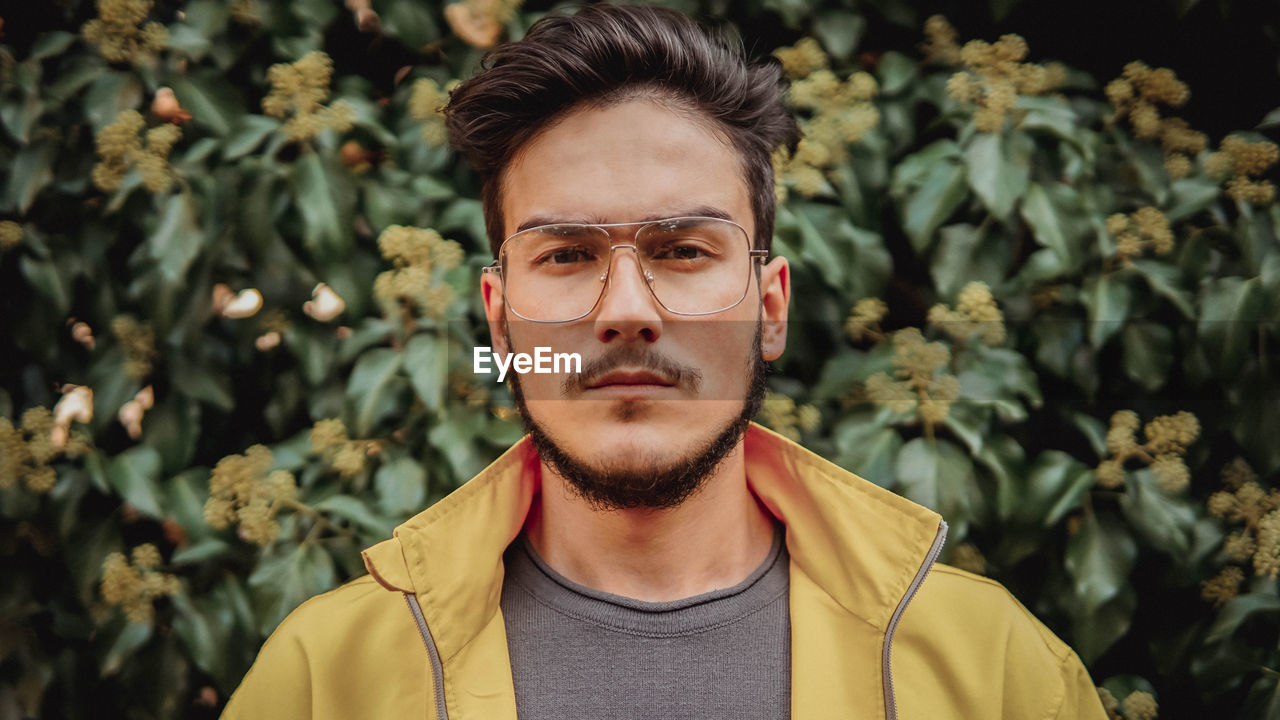 Portrait of young man against plants