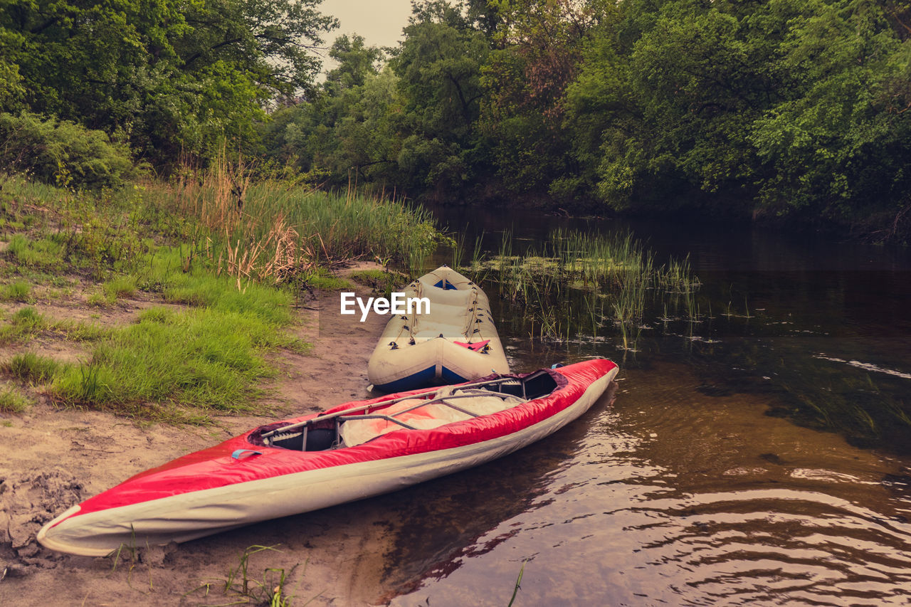 BOAT IN RIVER BY TREES