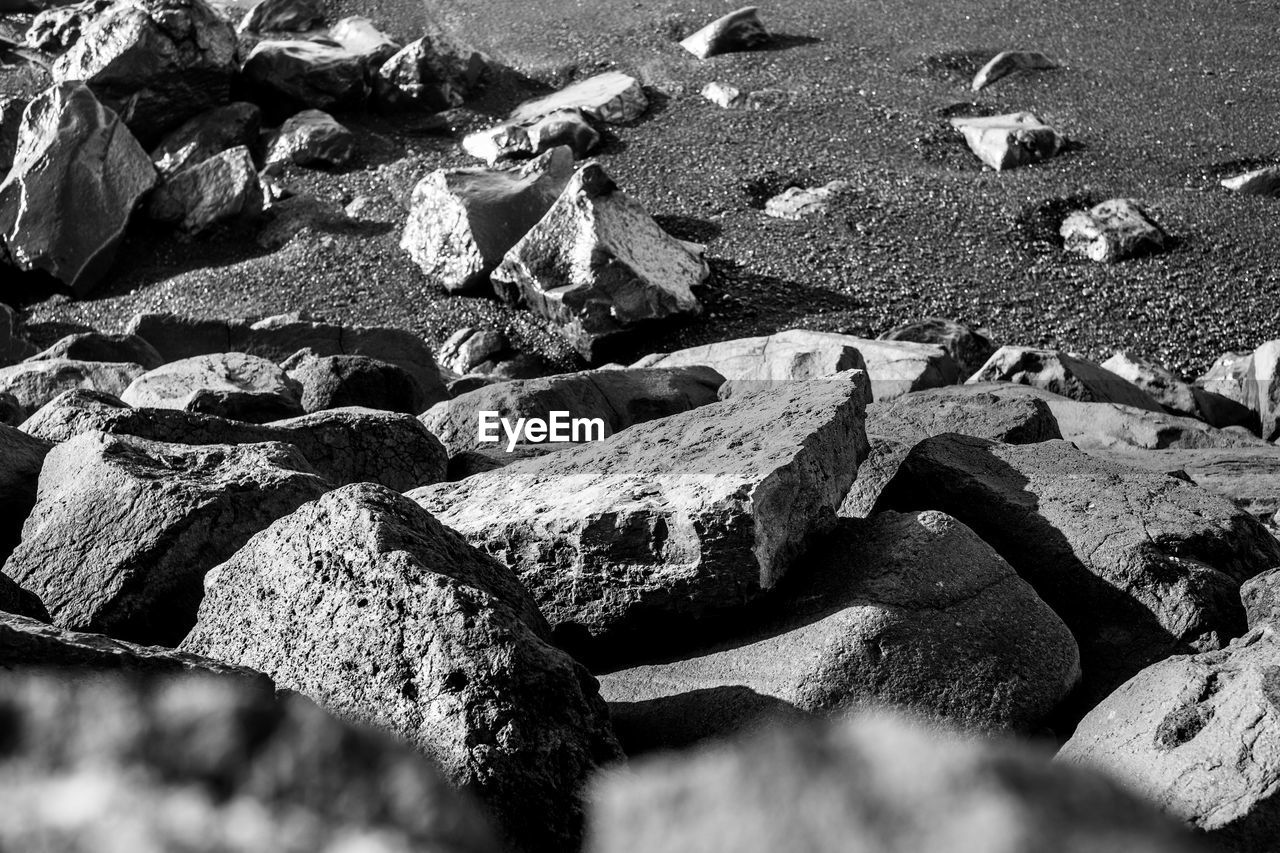 HIGH ANGLE VIEW OF ROCKS ON SHORE AT BEACH