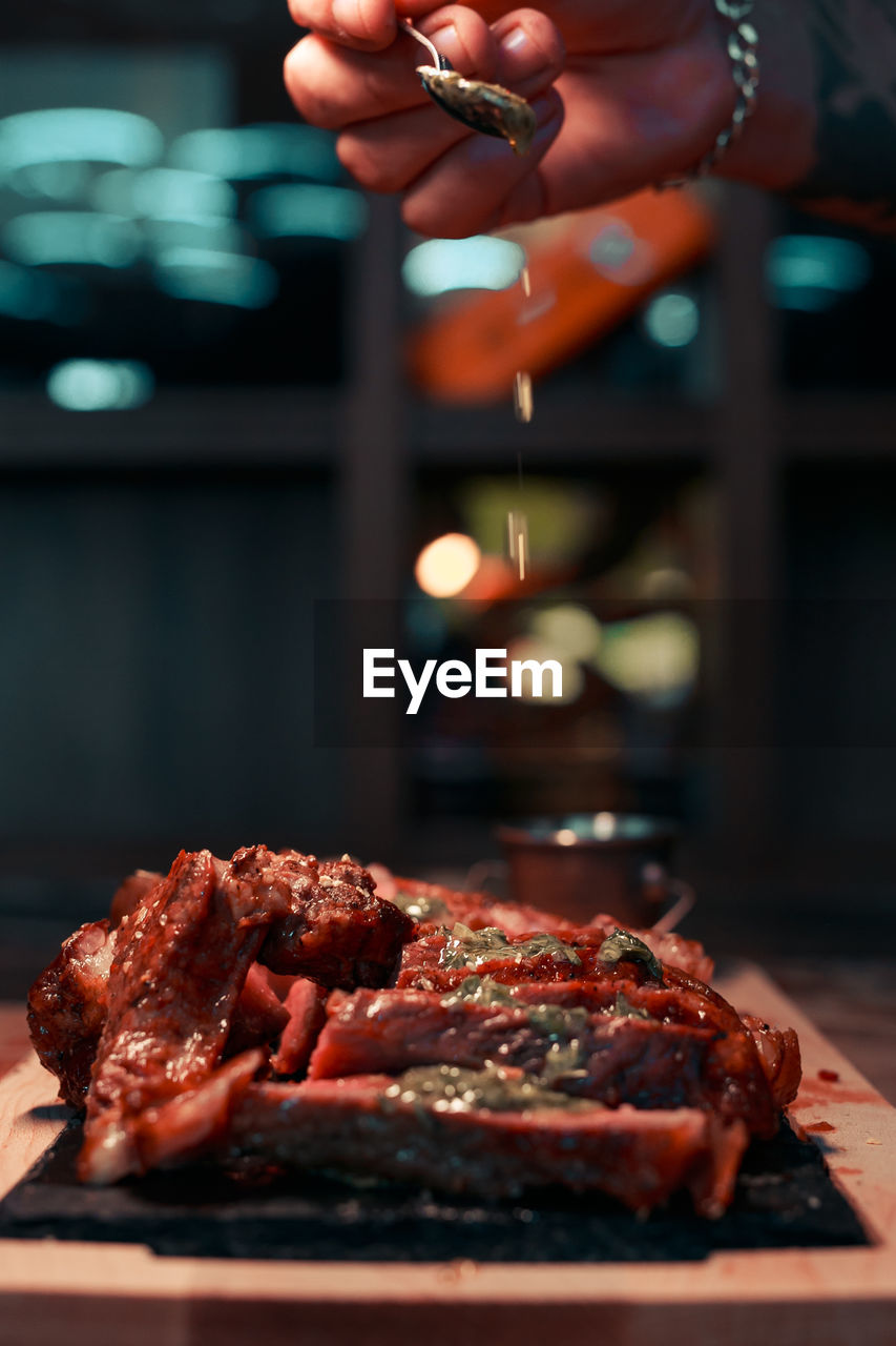 cropped hand of woman preparing food