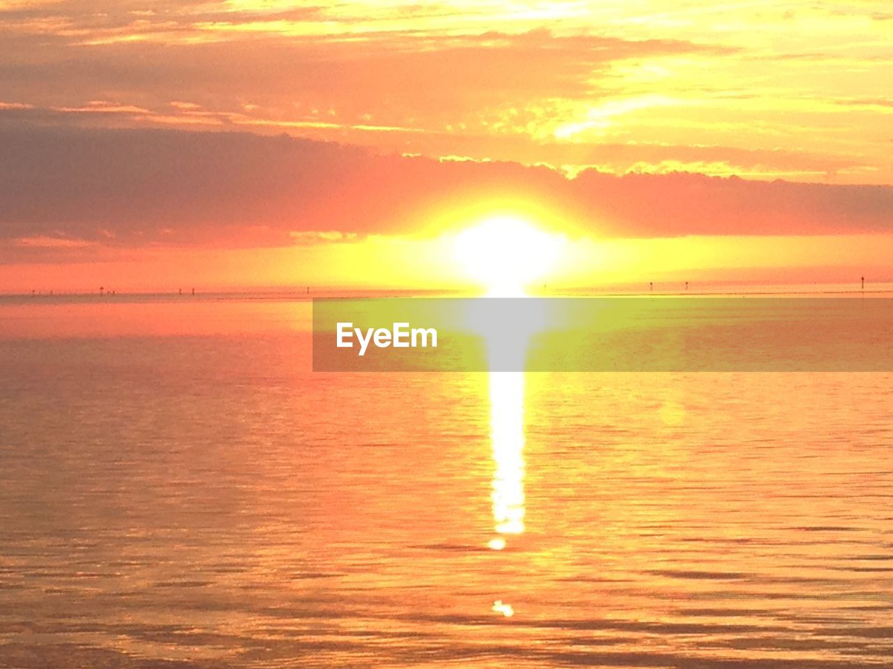 SCENIC VIEW OF SEA AGAINST ORANGE SKY DURING SUNSET