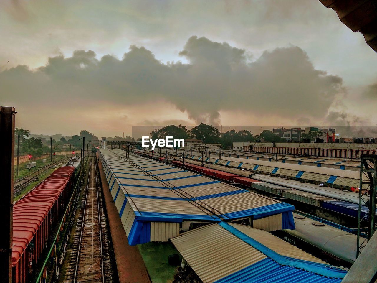 HIGH ANGLE VIEW OF TRAIN ON RAILROAD TRACKS AGAINST SKY