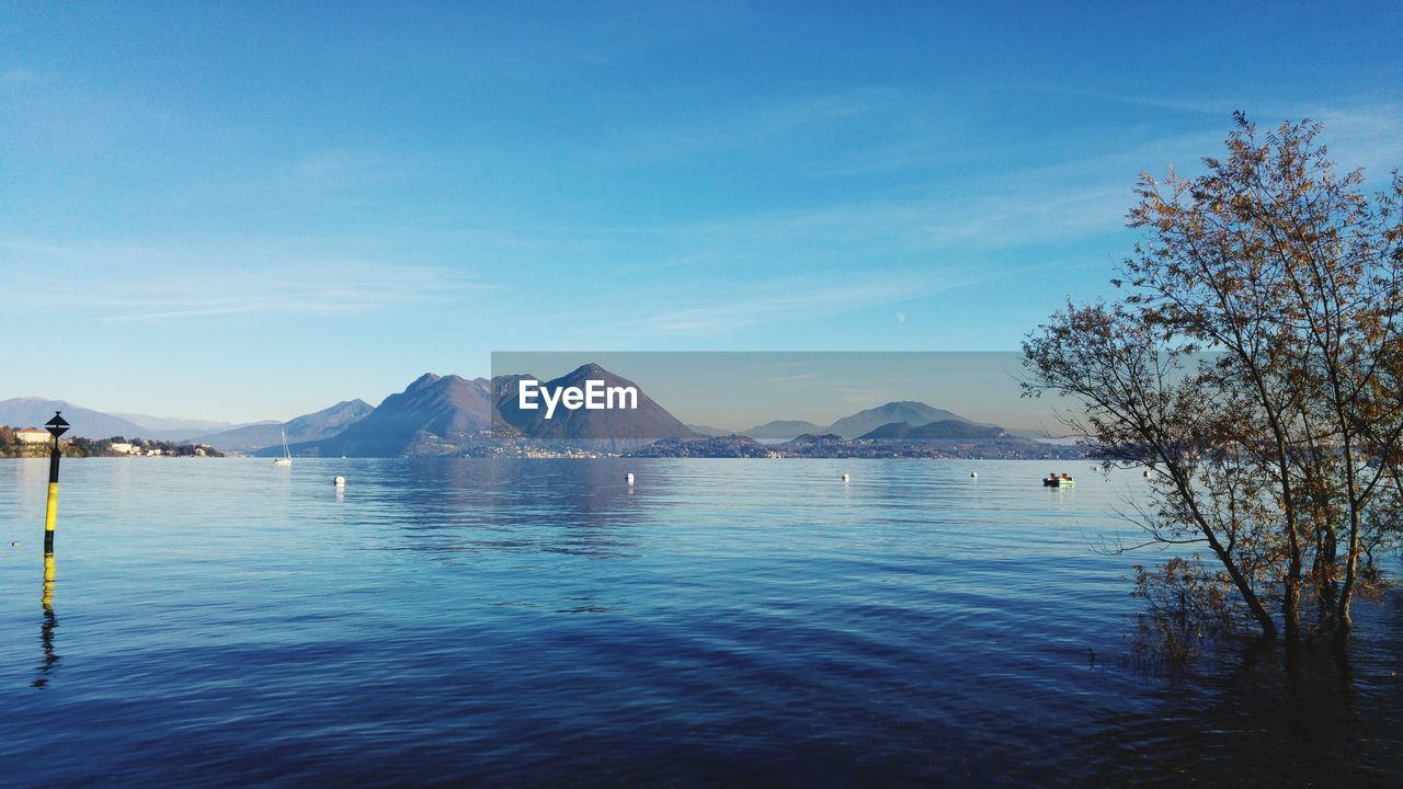 Scenic view of lake against blue sky