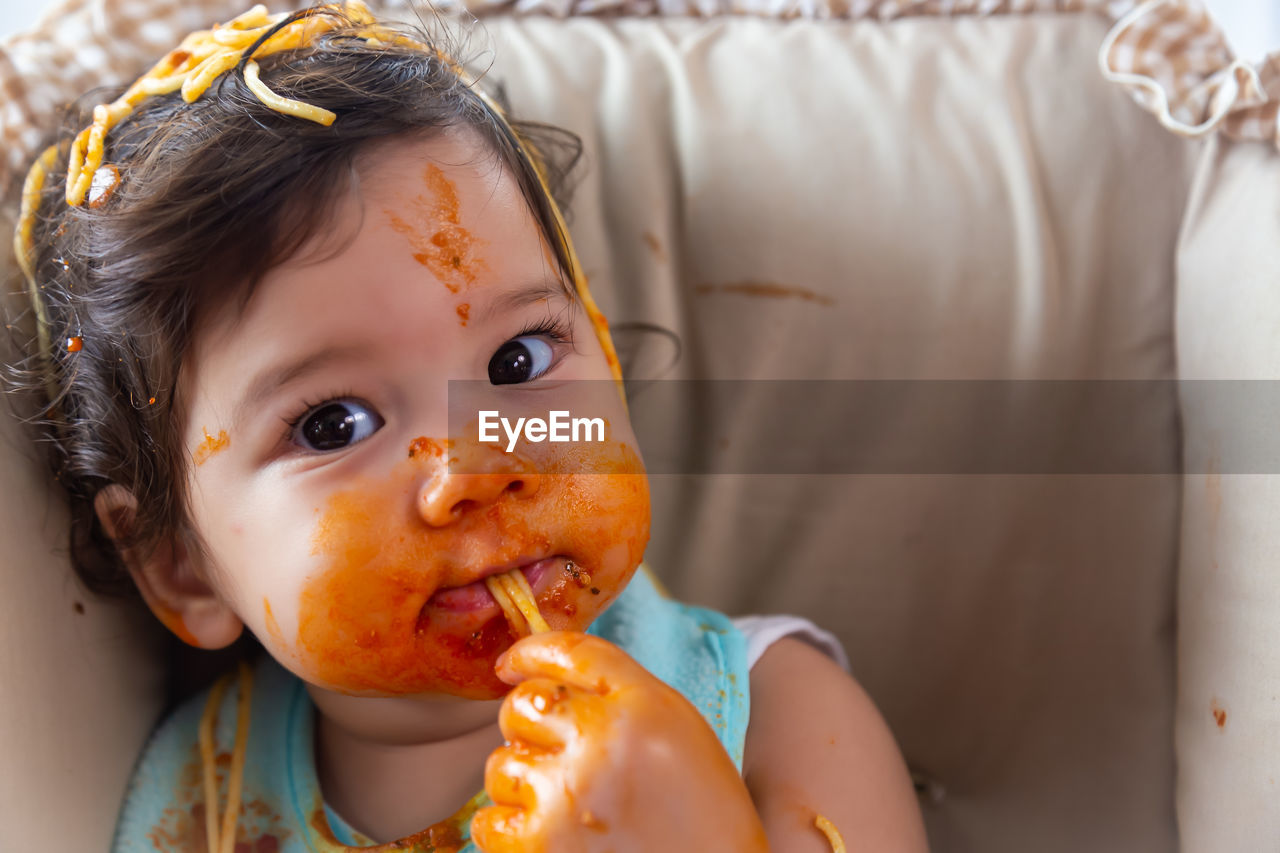 Close-up portrait of cute girl with eating food 