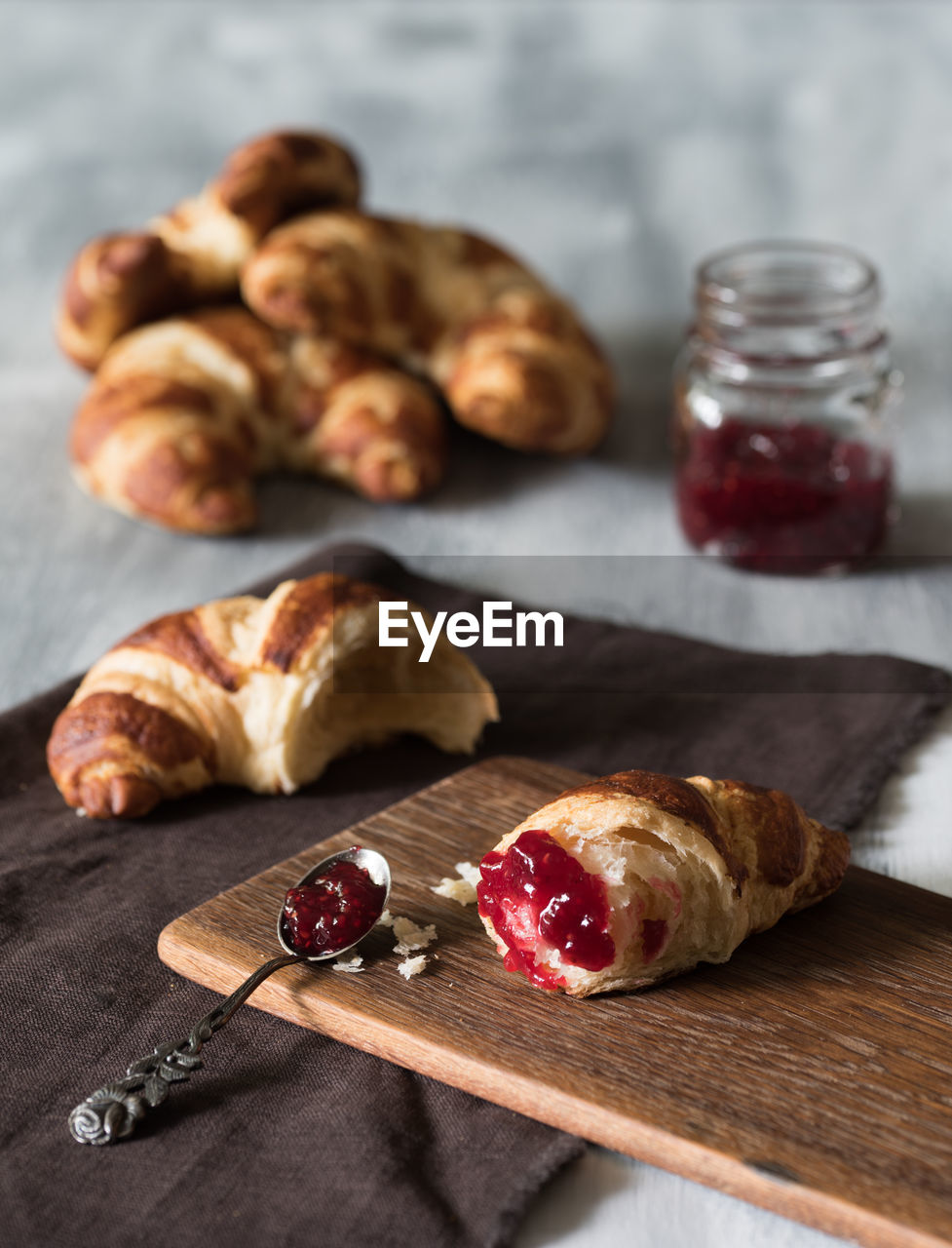 Close-up of croissants and jam on table