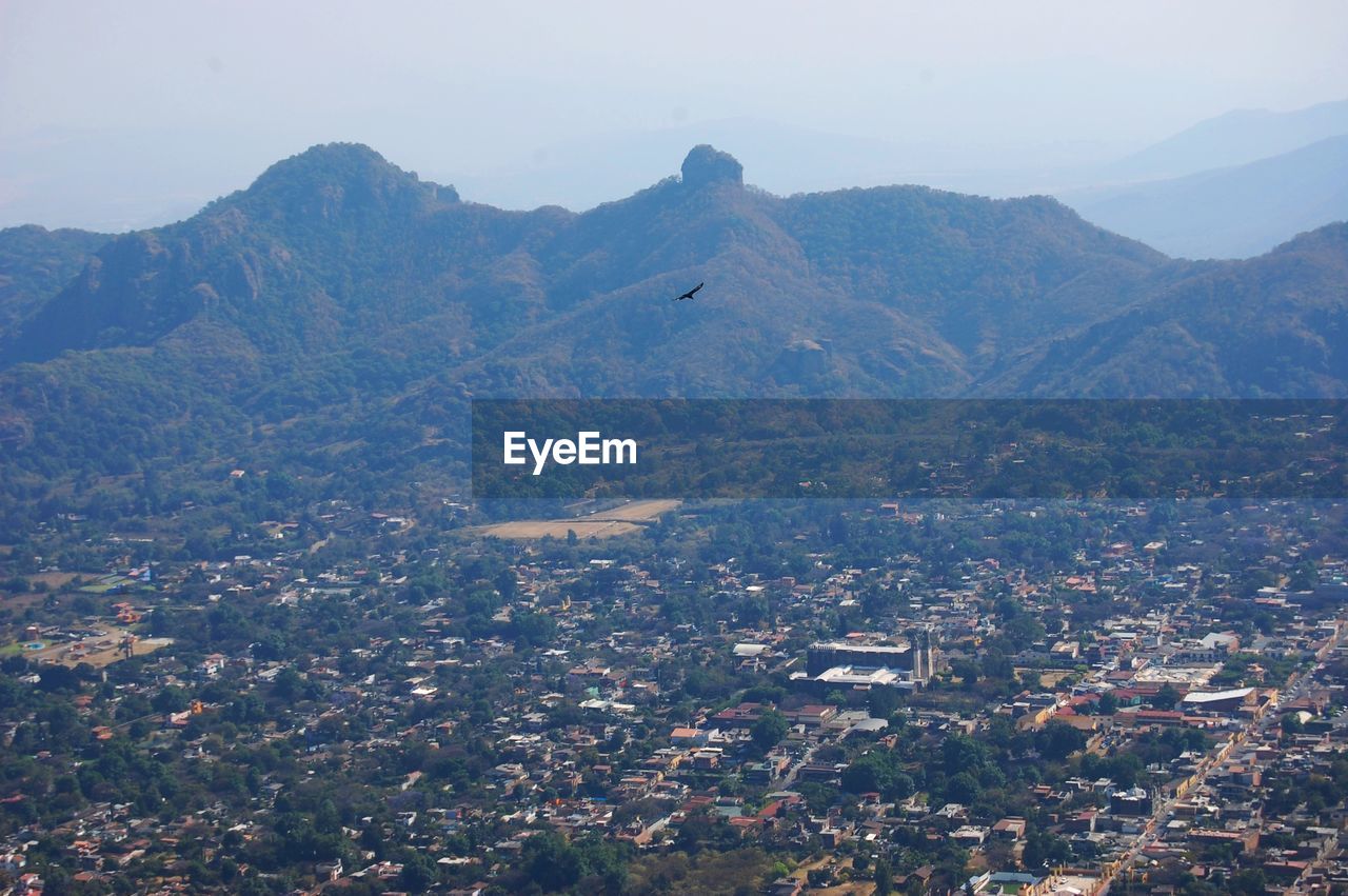 High angle view of townscape and mountains against sky