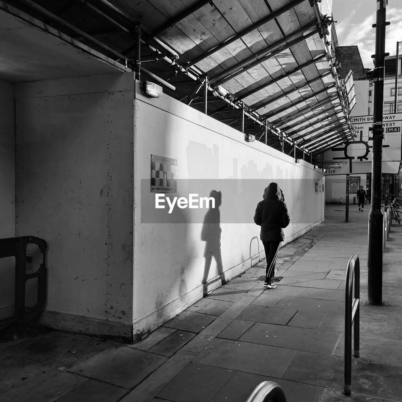 REAR VIEW OF PEOPLE WALKING IN SUBWAY